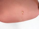 a small brown spot on the seat of a chair
