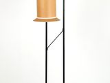 two lamps on a stand with a lamp shade on top of them