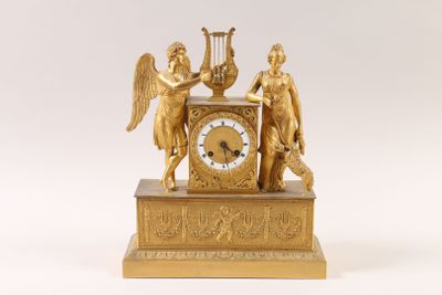 a gold clock with angels and harps on it