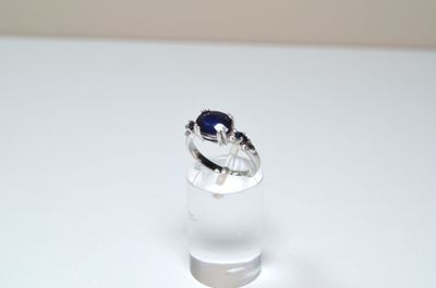 a ring with a blue stone in it sitting on a table