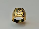 gros plan d'une bague en or sur une surface blanche