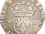 a silver coin with a crown on top of it