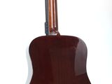 an image of a brown guitar sitting on top of a white surface