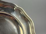 a silver plate with a handle on a table
