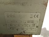 a machine that is sitting on top of a piece of wood