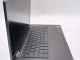 a black laptop with a silver keyboard on a white surface