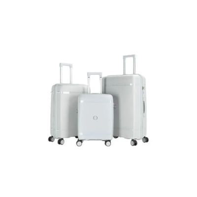 trois bagages empilés les uns sur les autres sur une surface blanche