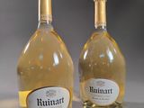 two bottles of wine sitting next to each other on top of a table