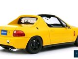 the yellow car is parked on a white surface with a price tag on the back of the car