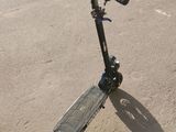 a scooter that is sitting in the sand