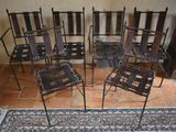 several chairs and a rug in a room with a fire place in the background