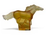 yellow glass horse figurine on a white surface with a white background