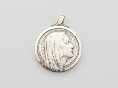 a silver coin with a profile of a woman in profile