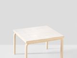 a white coffee table with a wooden frame on top of it