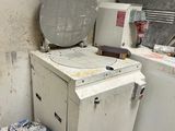 a white washer and a dryer in a dirty room