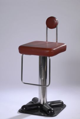 a red stool with a metal base and a red seat