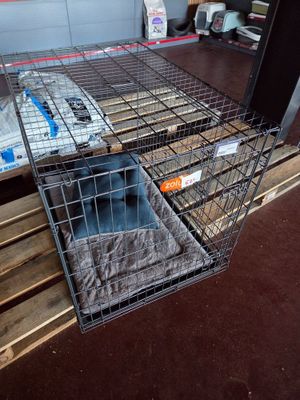 a cage that has a cat in it on a pallet