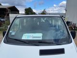 a white van with a sticker on it parked in a parking lot