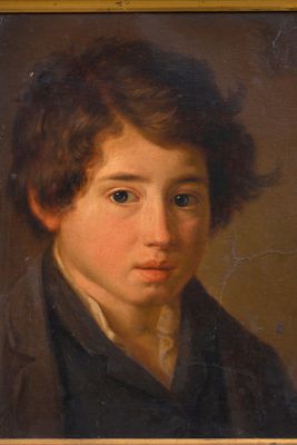 portrait of a young boy in a black shirt and a brown jacket