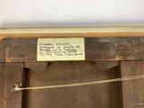 an old picture of a wooden frame with a sign attached to it