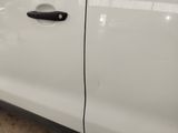 a close up of a car door handle on a white car