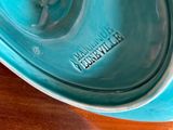 a blue bowl sitting on top of a wooden table