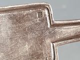 someone is holding a silver tray with a handle on it