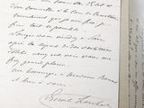 a handwritten letter on a piece of paper on a table