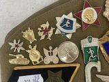 an image of a hat with a lot of badges on it