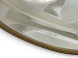 a silver plate with a spoon and a spoon rest on it