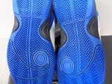 the soles of a pair of blue and black shoes