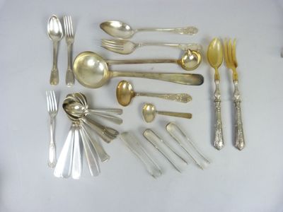 a lot of silver spoons and forks on the table