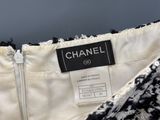 a close up of a chanel label on a black and white dress