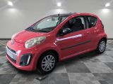 a picture of a small red car on a checkered floor