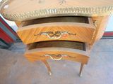 a small wooden table with two drawers on it
