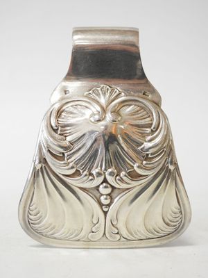 a silver vase sitting on a table with a white background