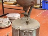 a large metal pot sitting on top of a table