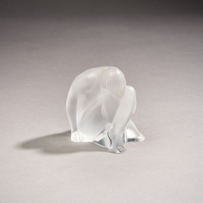 a glass elephant figurine sitting on a white surface