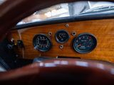 a steering wheel and gauges in the dashboard of a car