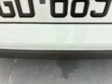 a close up of a white car with a number plate on it