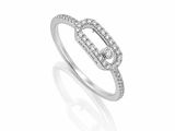 a close up of a diamond ring on a white background