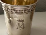a silver cup that is sitting on a table