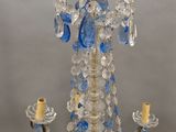a chandelier with blue and clear glass beads hanging from it