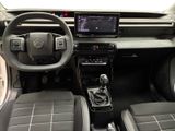the interior of a car with a steering wheel, dashboard, and dashboard controls