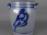 a blue and white vase with a bird on it