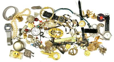 a pile of assorted jewelry on a white surface