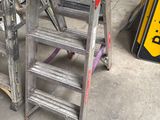 two ladders sitting next to each other in a garage