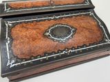 a small wooden box with a decorative design on it