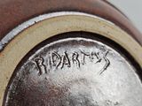a close up of a brown vase with writing on it