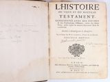 an old book with writing on it sitting on top of a table